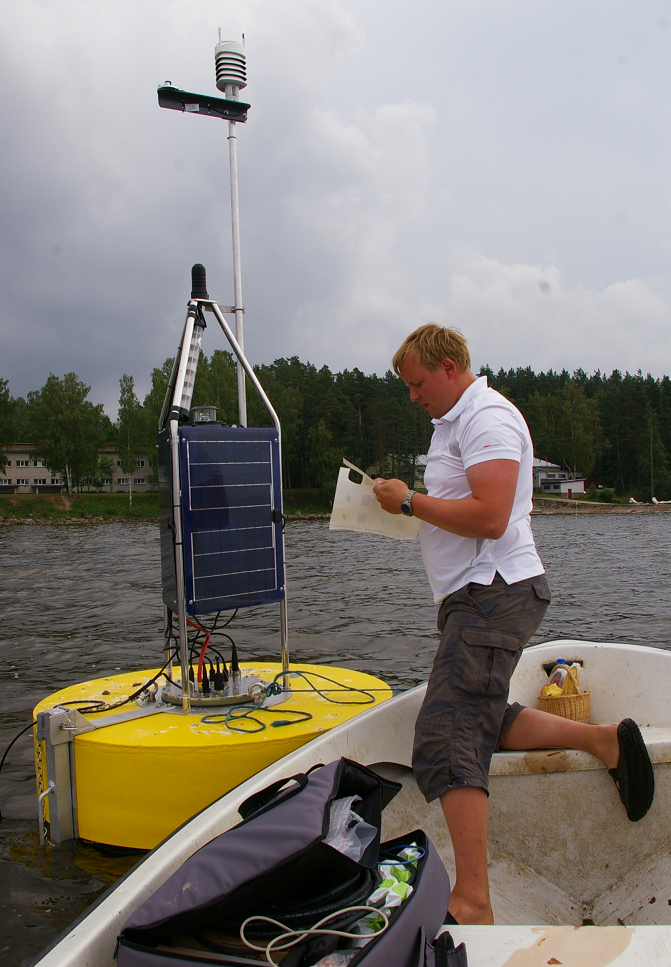 Alo Laas on the lake with a buoy that measures water parameters